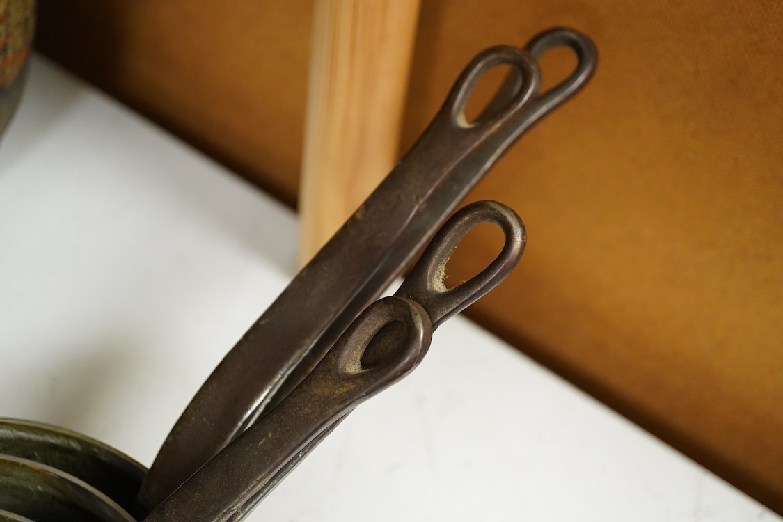 A graduated set of five copper saucepans